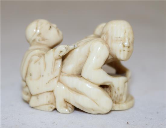 A Japanese ivory netsuke of a rat catcher and a boy, Meiji period, length 3.9cm